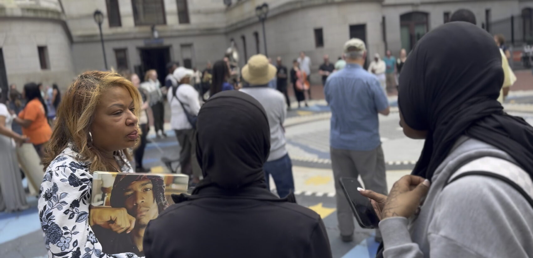 Charriba Gordon holds a photo of her son