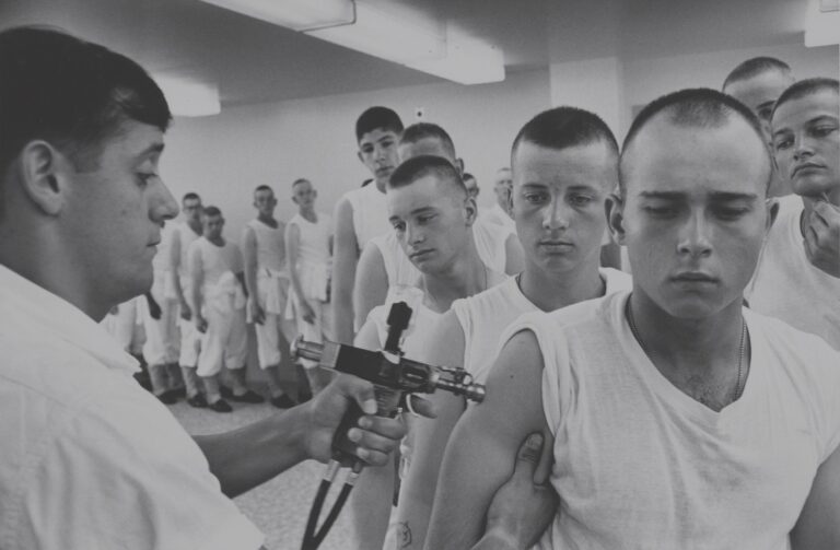 Navy recruits in 1965 wait in line for immunizations