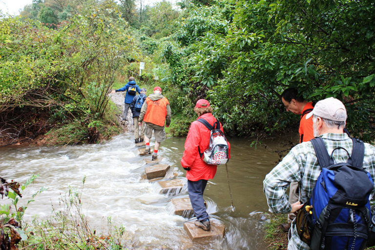 Hikers crossing the Wissahickon creek