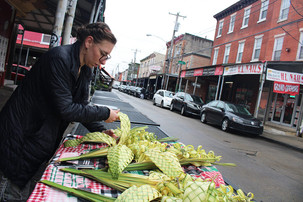 palm-weavers-1 A woman weaves designs with palm fronds in Philadelphia's Italian market.