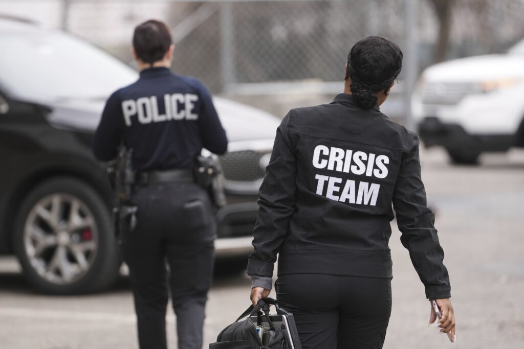 Mental Health Police-Philadelphia Two police officers from the Crisis Team head towards a car