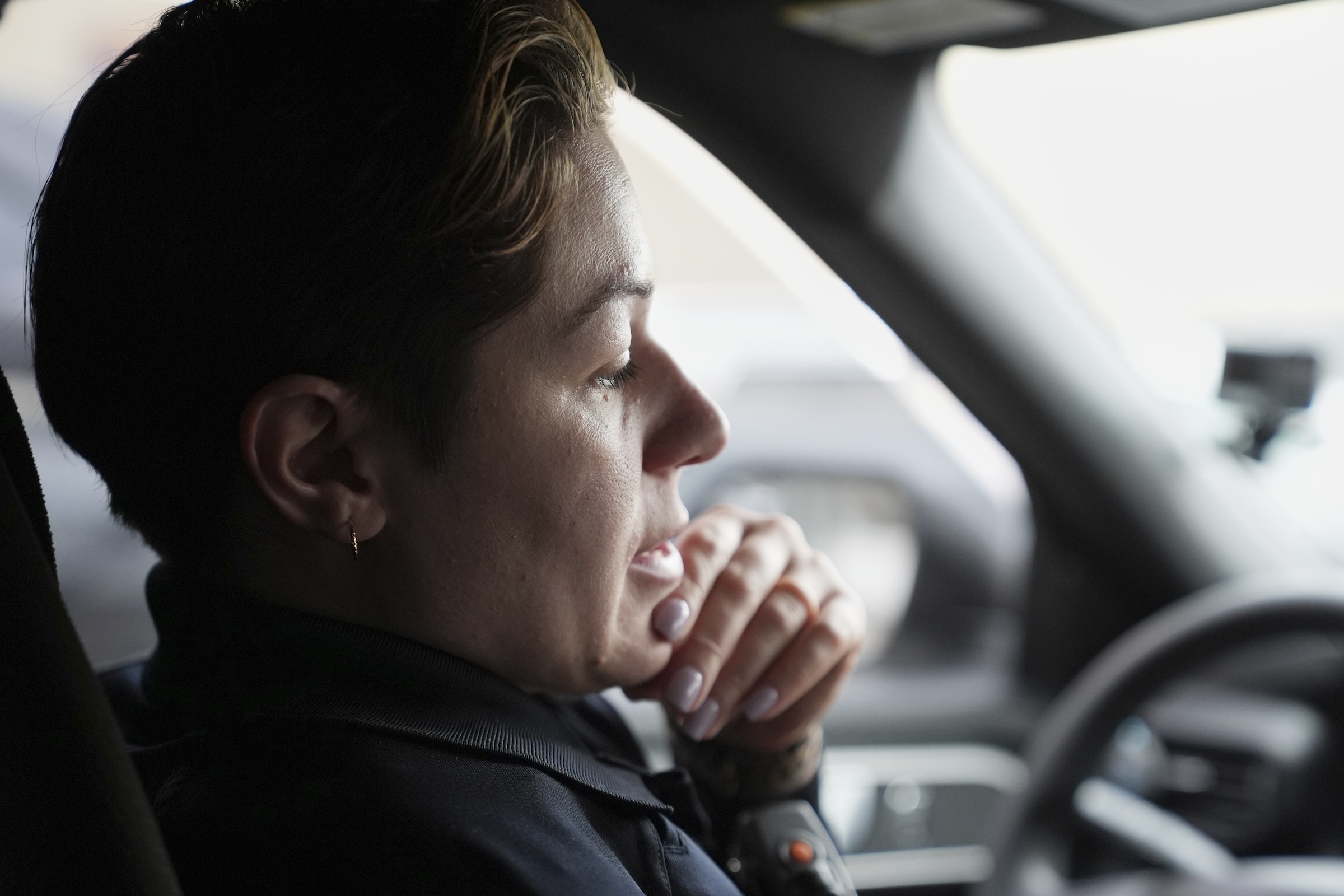 Vanity Cordero sitting in the driver's seat of her car