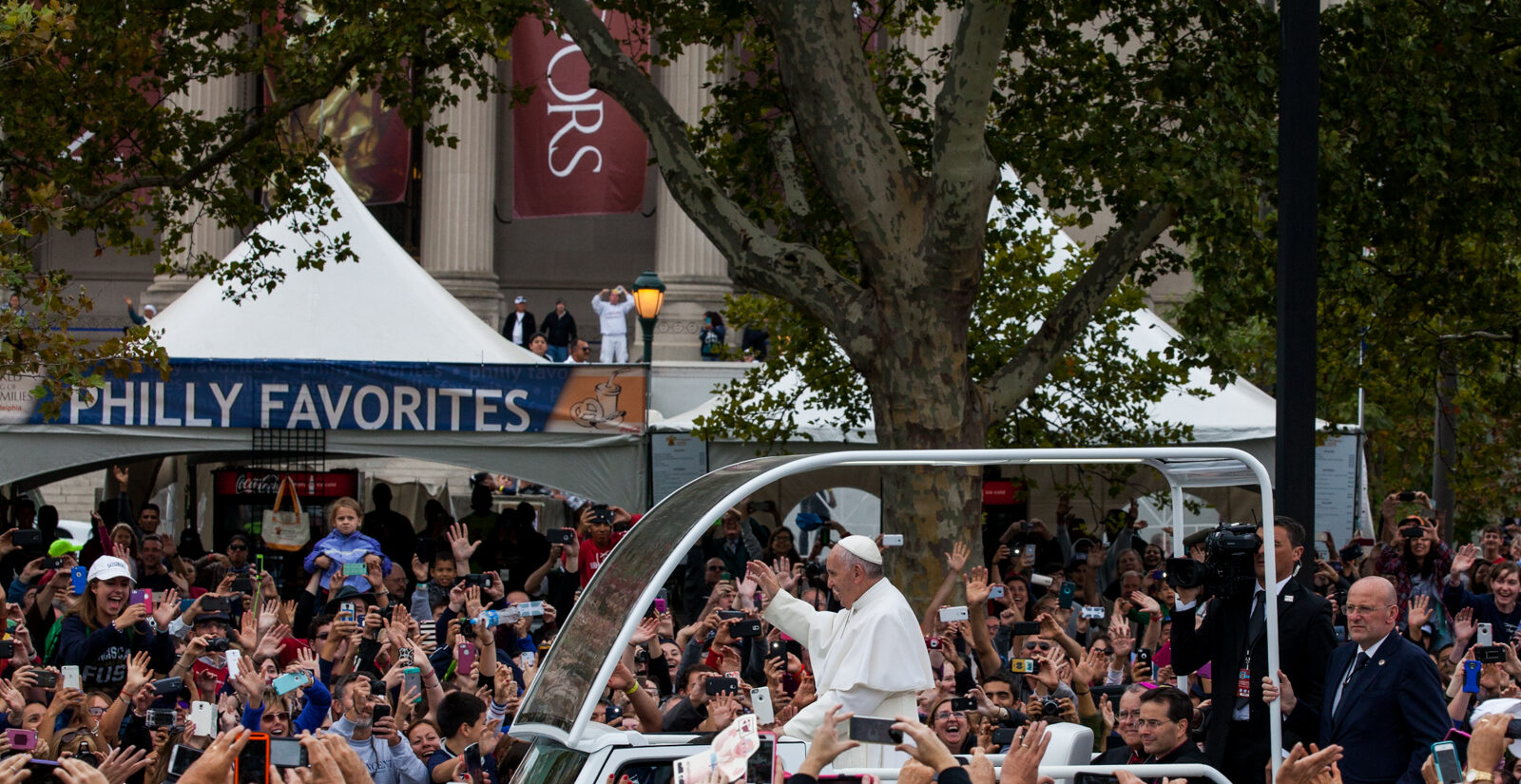 Pope Francis waves at the crowd gathered around Logan Circle