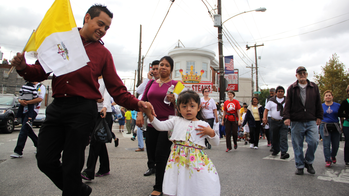 Jose Fernandez and his daughter walk with a crowd near Geno's
