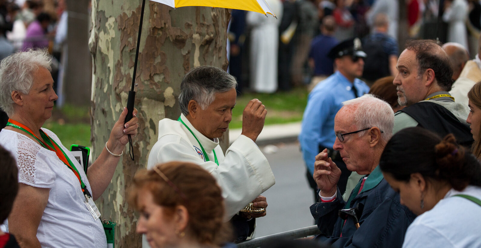 people in a crowd take communion