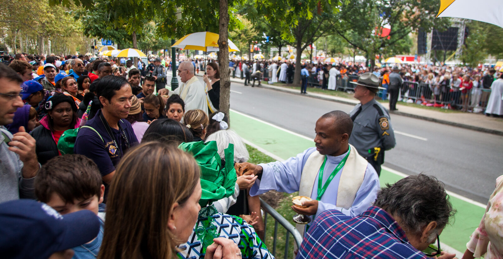people in a crowd take communion