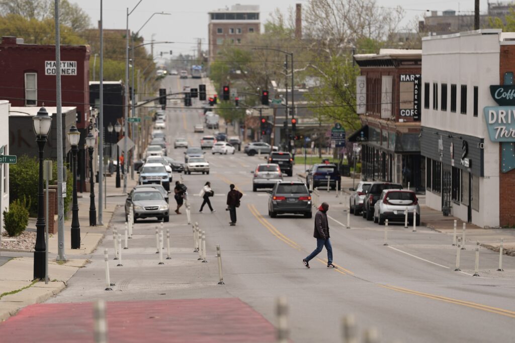 People cross 31st Street in Kansas City, Mo.