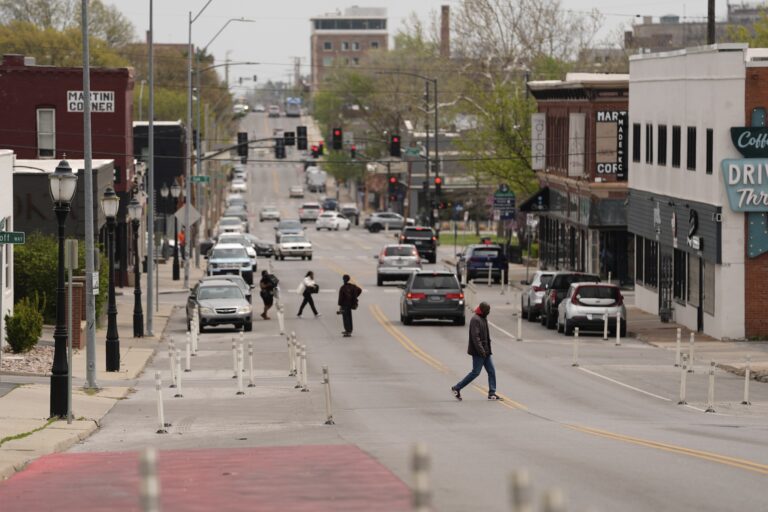 People cross 31st Street in Kansas City, Mo.