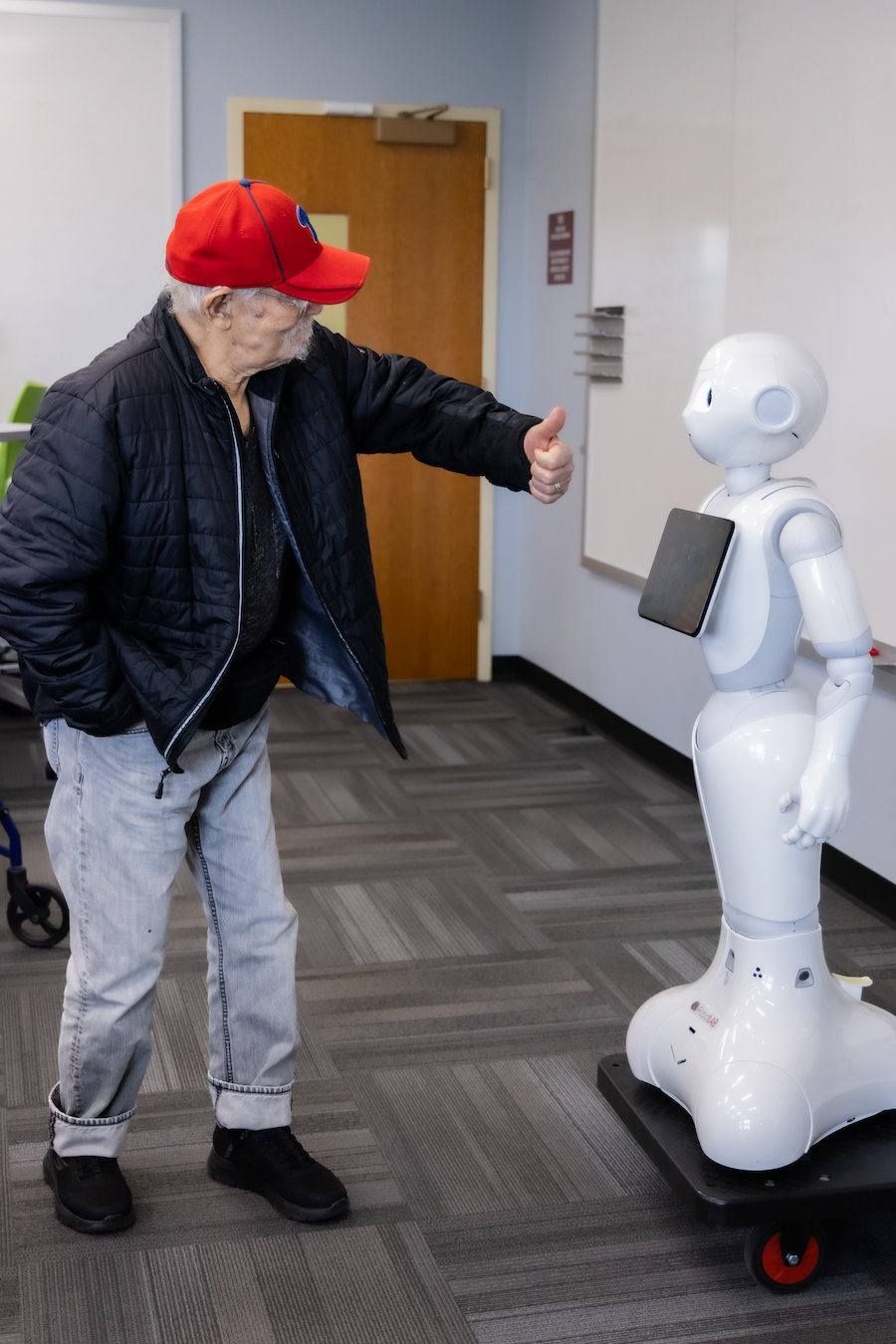 A Bancroft resident gives a thumbs up to the robot