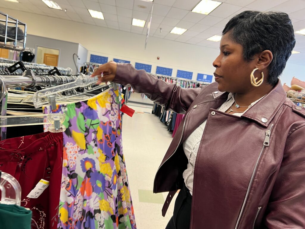 thirft-store-tarrif-silver-lining-ZR-041825-O5 Woman observing clothing rack at B-Bop Vintage in Philadelphia