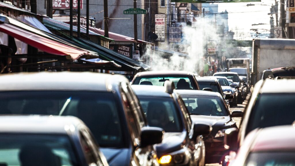 Philadelphia traffic – 9th Street Italian Market. Cars sitting in traffic on a busy street