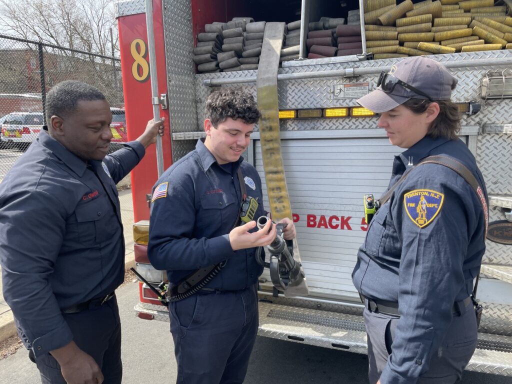 Three firefighters speaking together