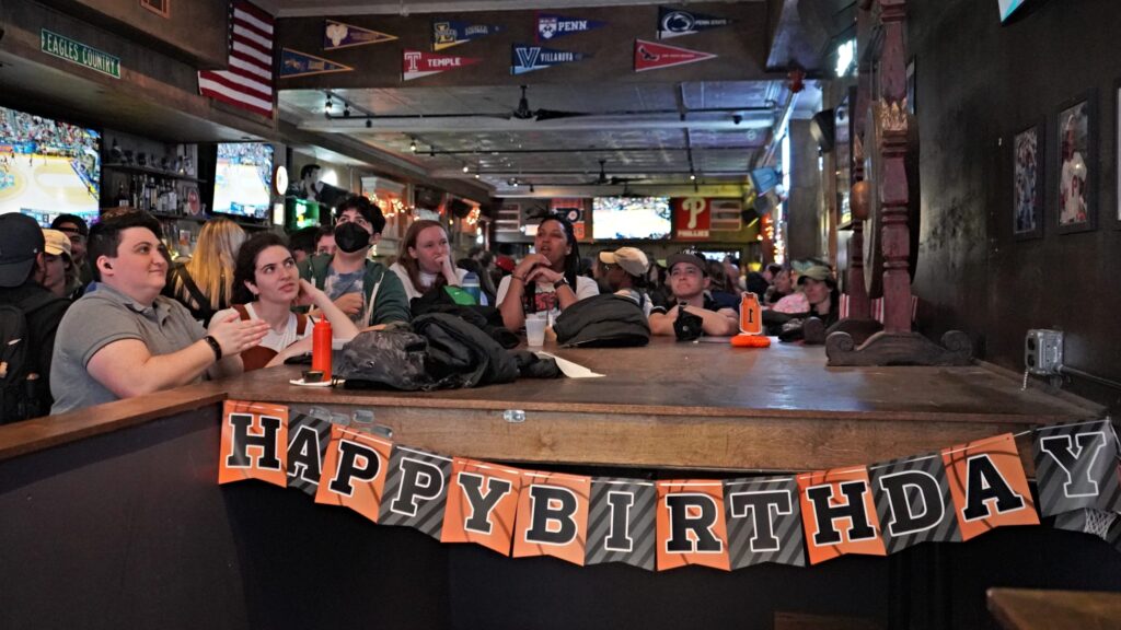 People watching sports on tvs at a bar