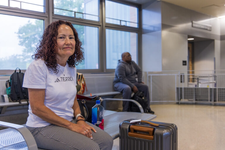 Mary Ann Howard sits in an NJ Transit station
