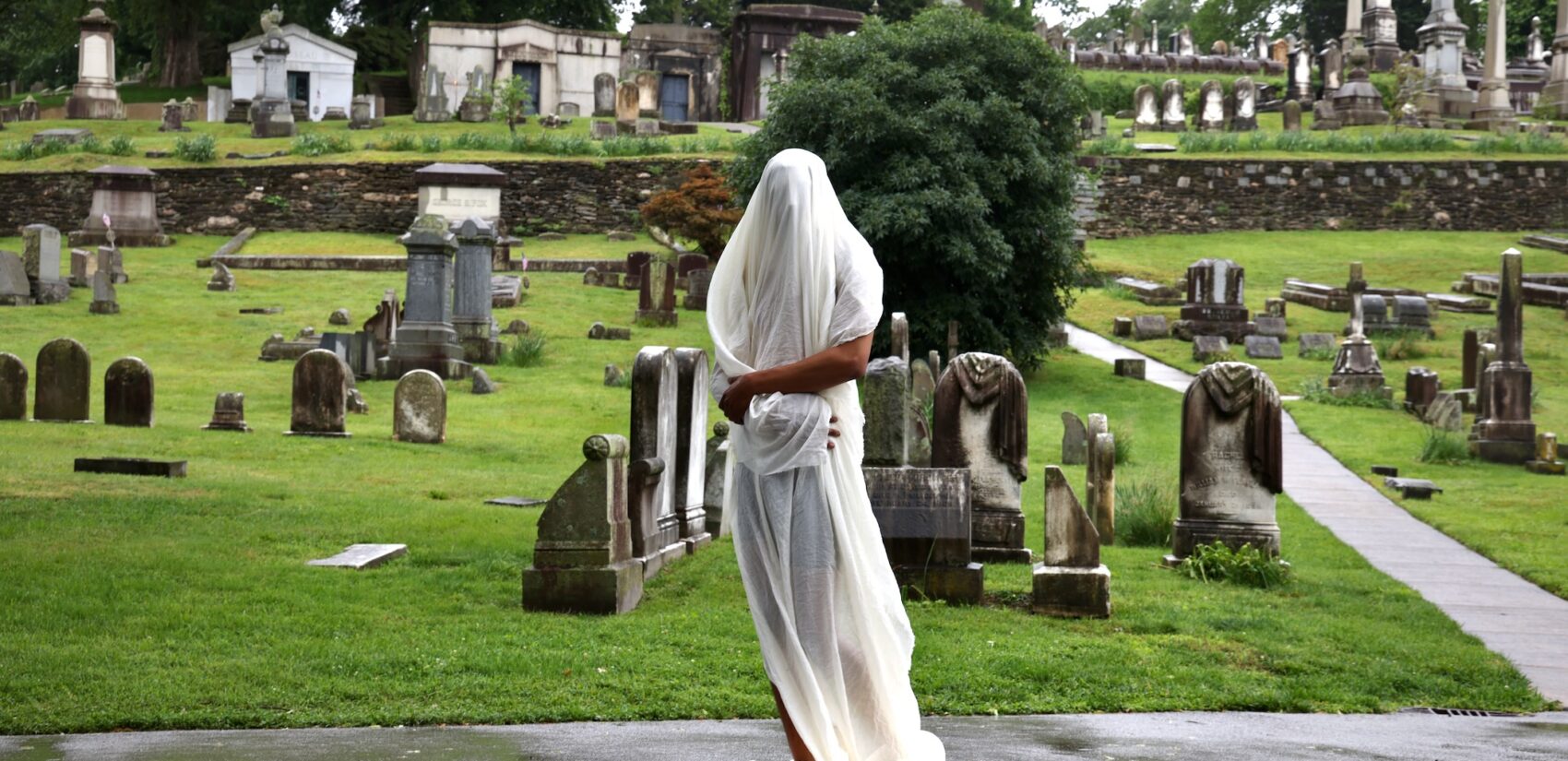 DonChristian Jones with a sheet over his body for a performance at Laurel Hill Cemetery for the Death and Arts Festival