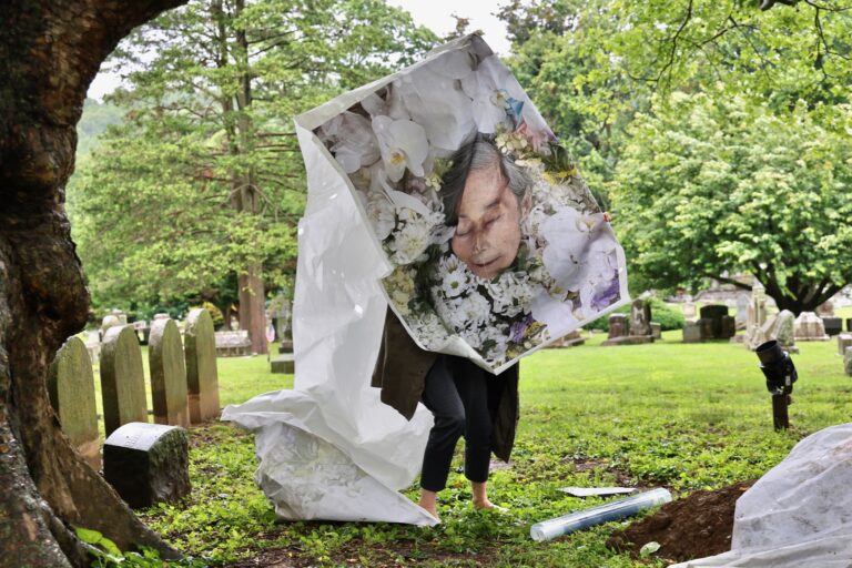 Eiko Otake holds an image of her mother for a performance at Laurel Hill Cemetery for the Death and Arts Festival