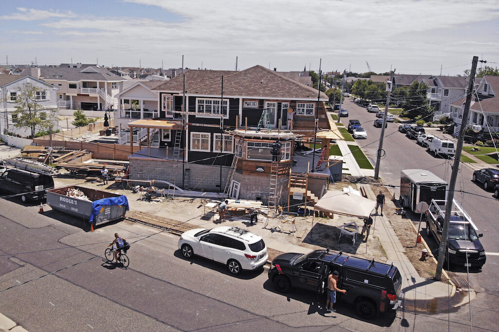 In this image from a drone, workers construct a new house elevated with cinder blocks in Stone Harbor, New Jersey, on Thursday, July 23, 2020. (AP Photo/Ted Shaffrey)
