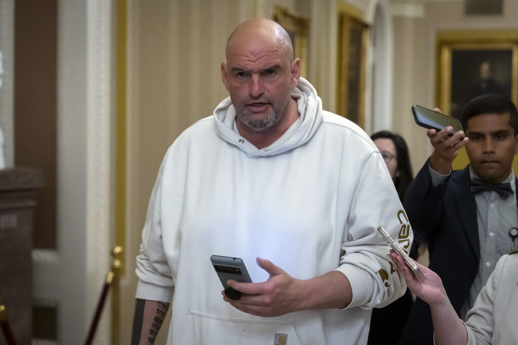 Sen. John Fetterman, D-Pa., speaks to reporters as he walks near the Senate chamber at the Capitol in Washington. (AP Photo/Ben Curtis)