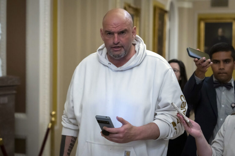 Sen. John Fetterman, D-Pa., speaks to reporters as he walks near the Senate chamber at the Capitol in Washington. (AP Photo/Ben Curtis)
