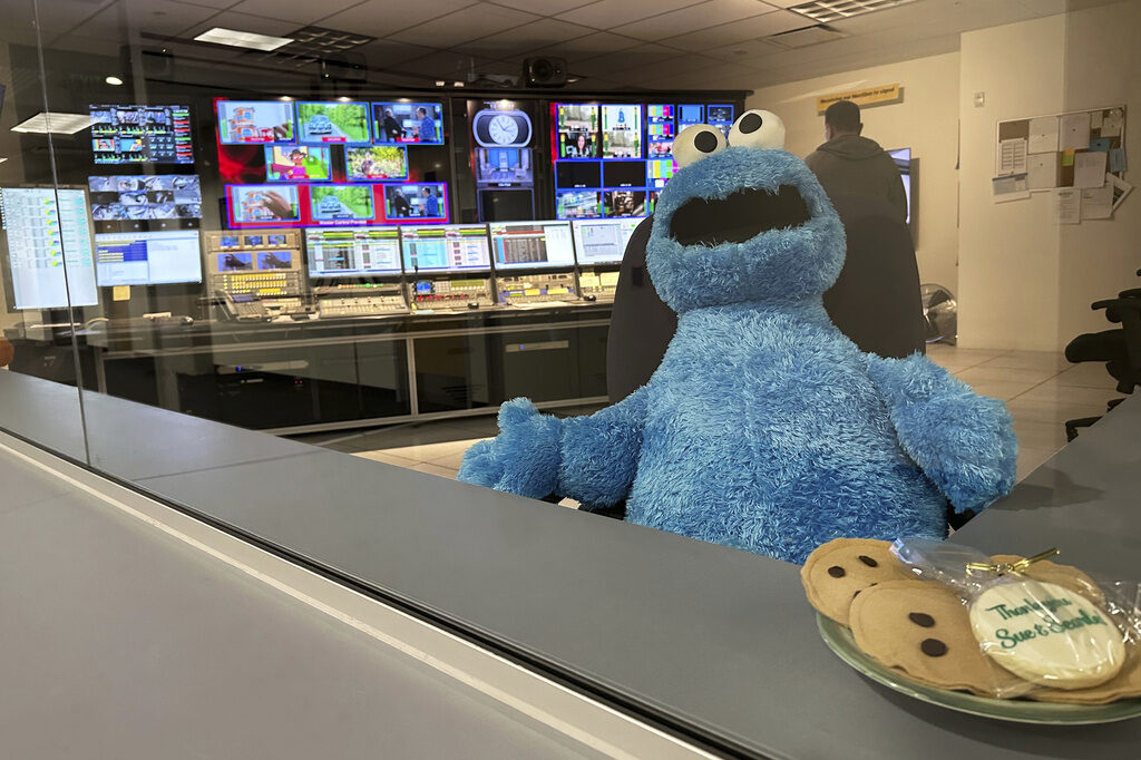 A stuffed Cookie Monster is seated in a control room at the Arizona PBS offices