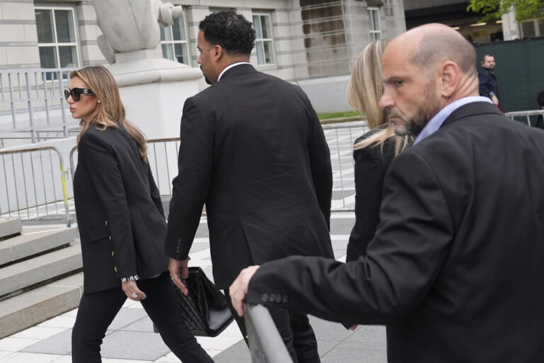 Interim US Attorney for New Jersey Alina Habba walks with men dressed in suits