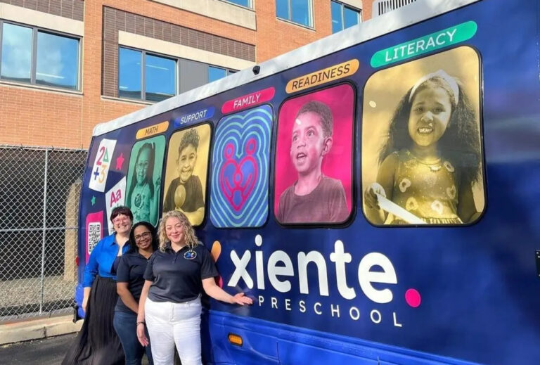 Xiente Busesito leaders stand in front of the Busesito mobile pre-K bus