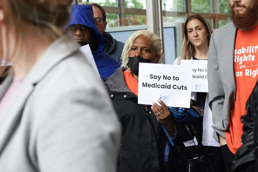 A woman holds a sign that says "say no to Medicaid cuts" at a rally in Philadelphia
