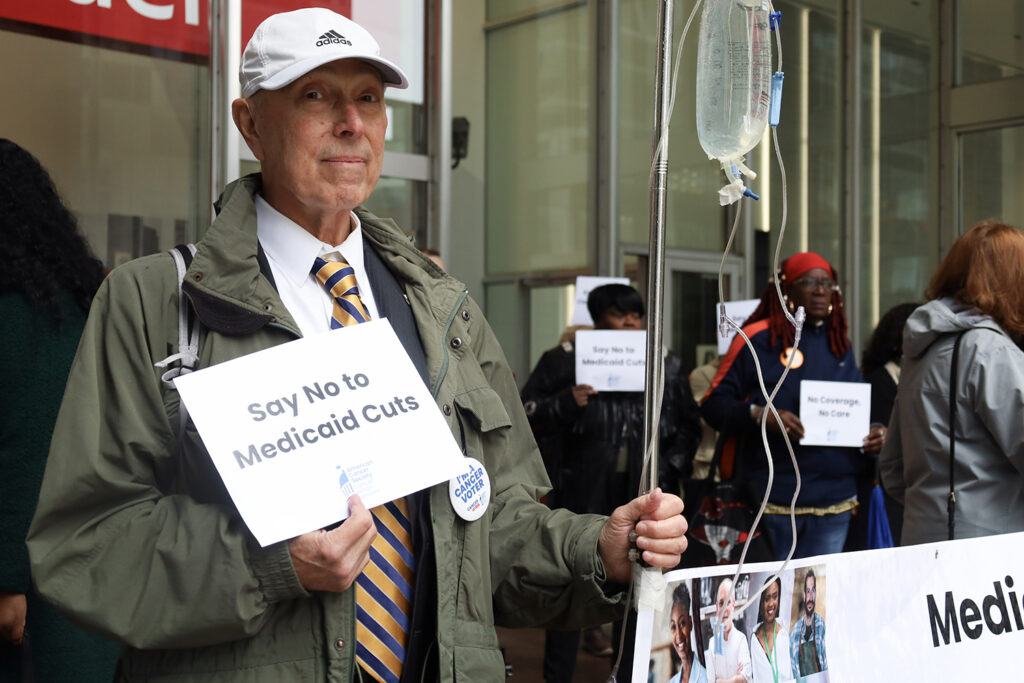 Cancer Medicaid rally5 copy A man holds a sign that says