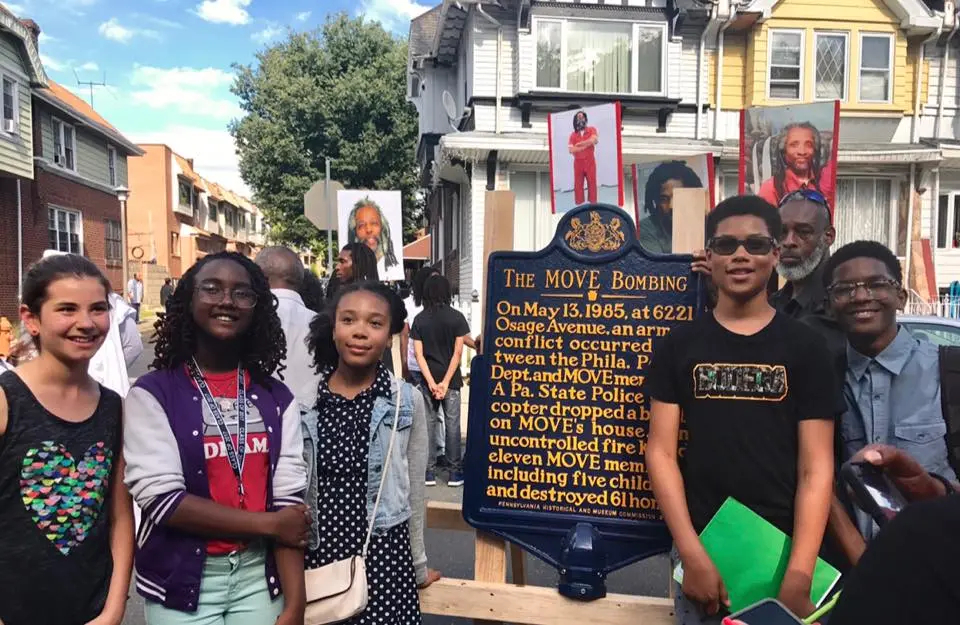 Hannah Roemer-Block, Ishtar El, Ella Adams, David Bannister and Nigel Carter pose with the MOVE bombing historical marker during its unveiling ceremony on June 24, 2017