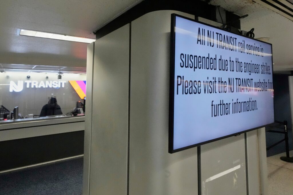 a sign reads All NJ TRANSIT rail service is suspended due to the engineer strike. Please visit the NJ TRANSIT website for further information.