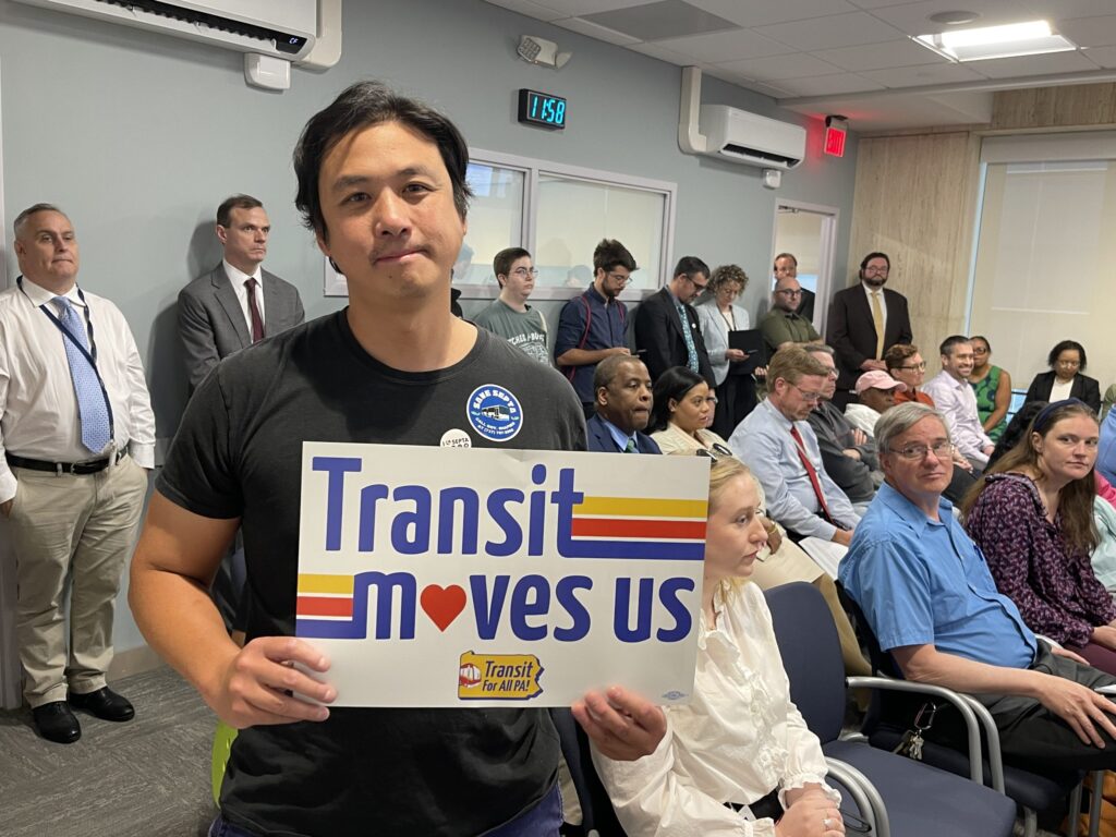 Will-Tung-septa-protest Will Tung holding up a sign that says 'Transit moves us'