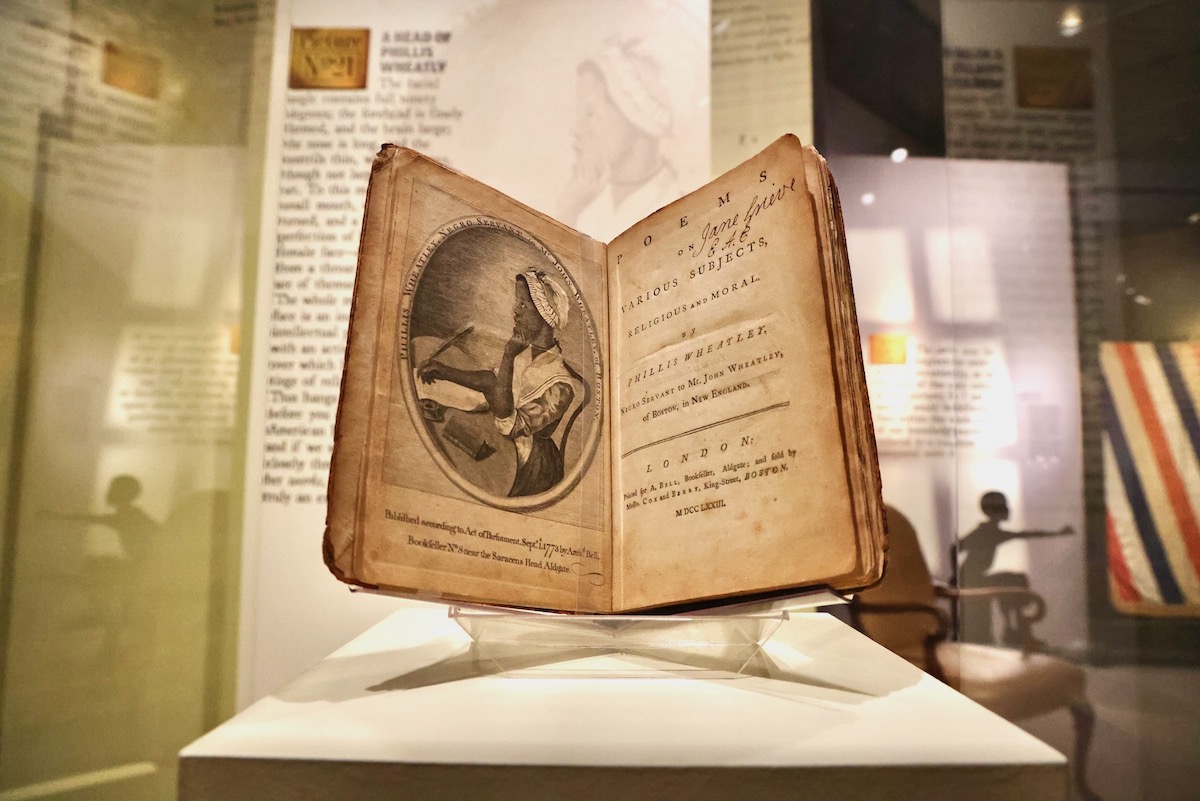 A portrait of Phillis Wheatly on display at art exhibit