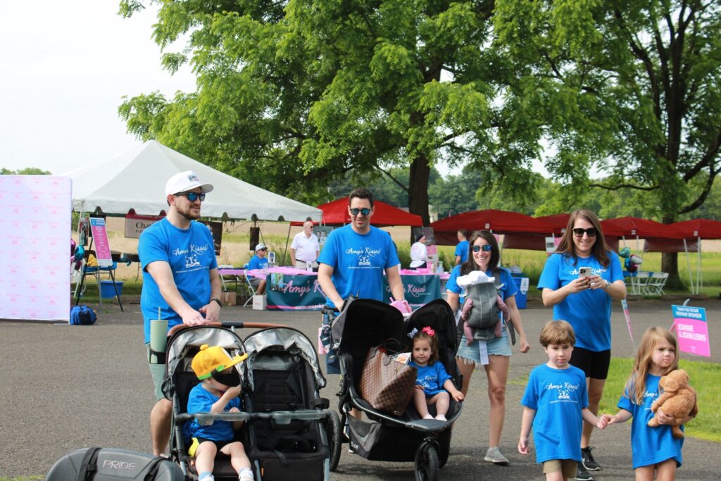 A group of people wearing 'Amy's Kisses' shirts