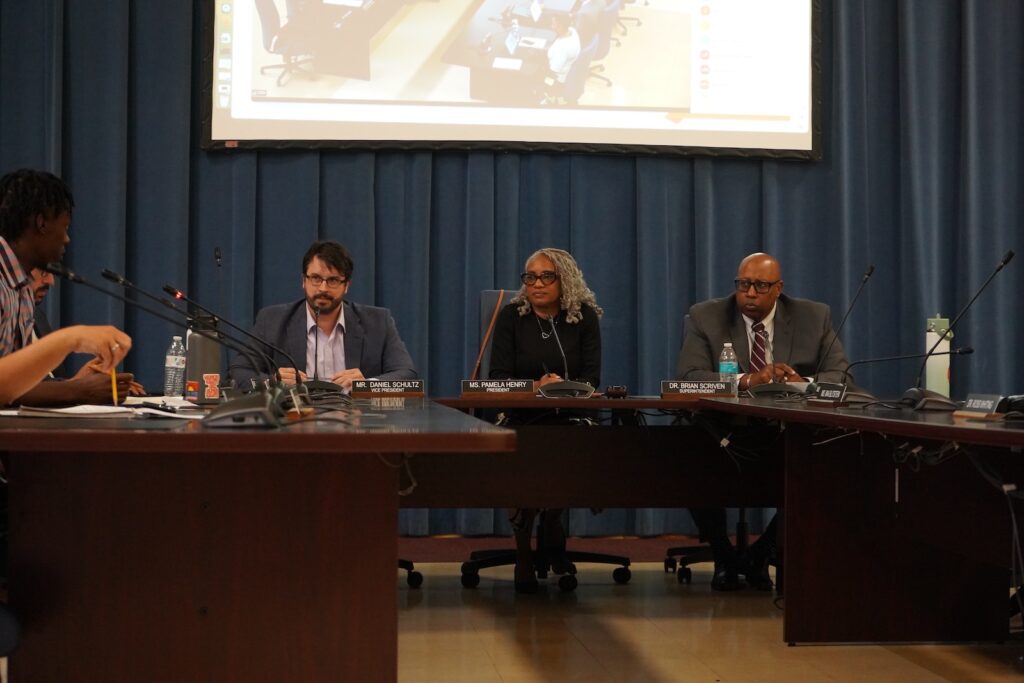 Cheltenham School District Board of Directors Daniel Schultz (left) and Pamela Henry (center) and Superintendent Brian Scriven are seen at a school board meeting