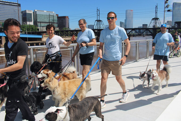 People walk their dogs on a new section of the Schuylkill River Trail