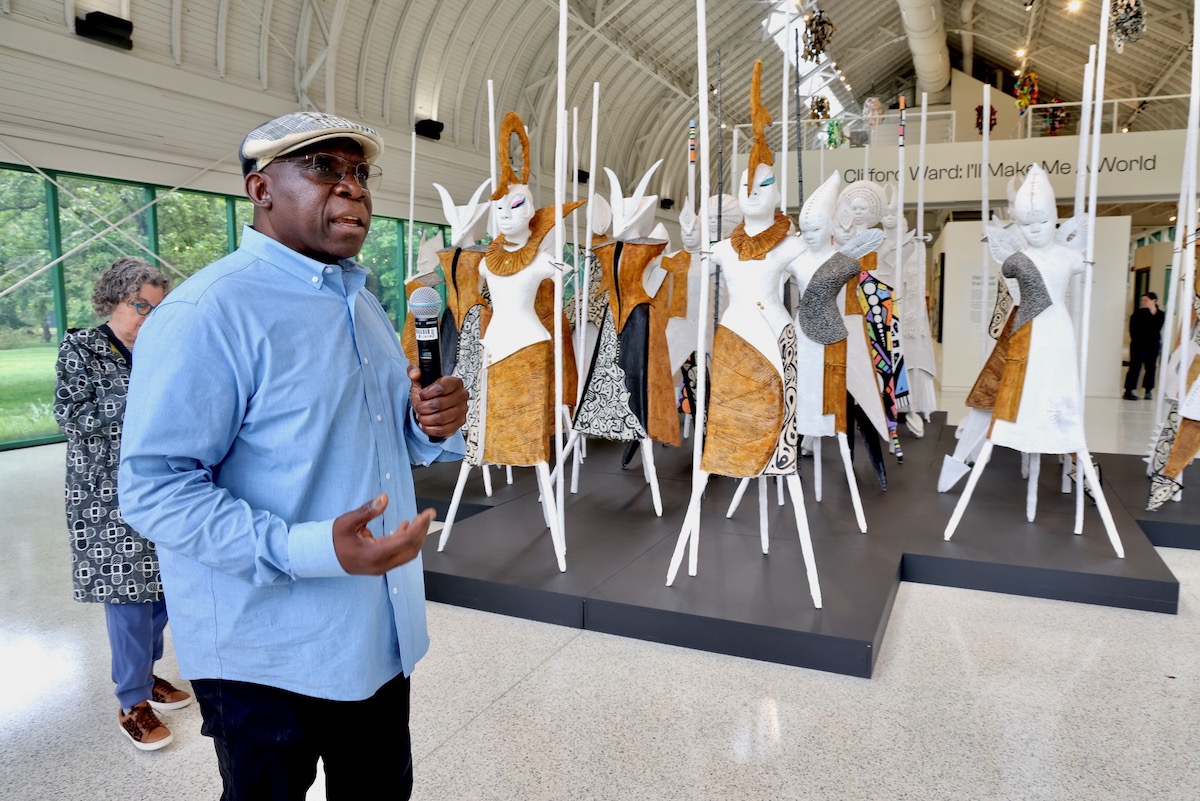 Clifford Ward guiding visitors through his exhibition