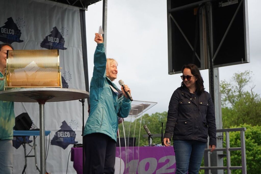 Frances Sheehan waving raffle winning
