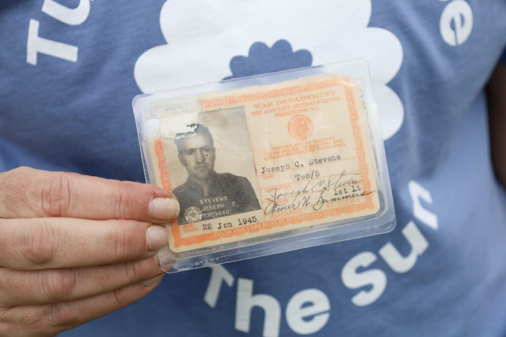 Collie Turner holding photos of her grandfather, Joseph C. Stevens,