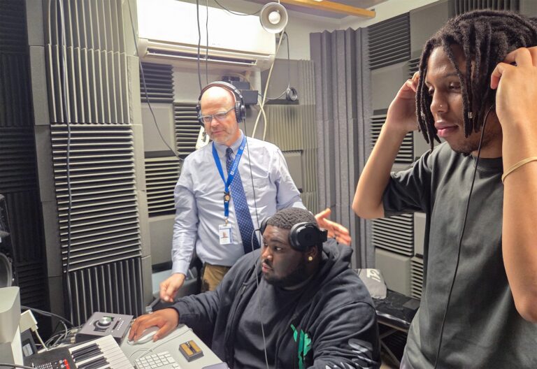 Students in the recording studio with their teacher