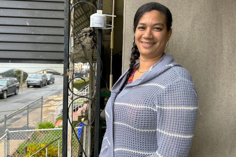 Tina Alishia Brown poses for a photo on her front porch