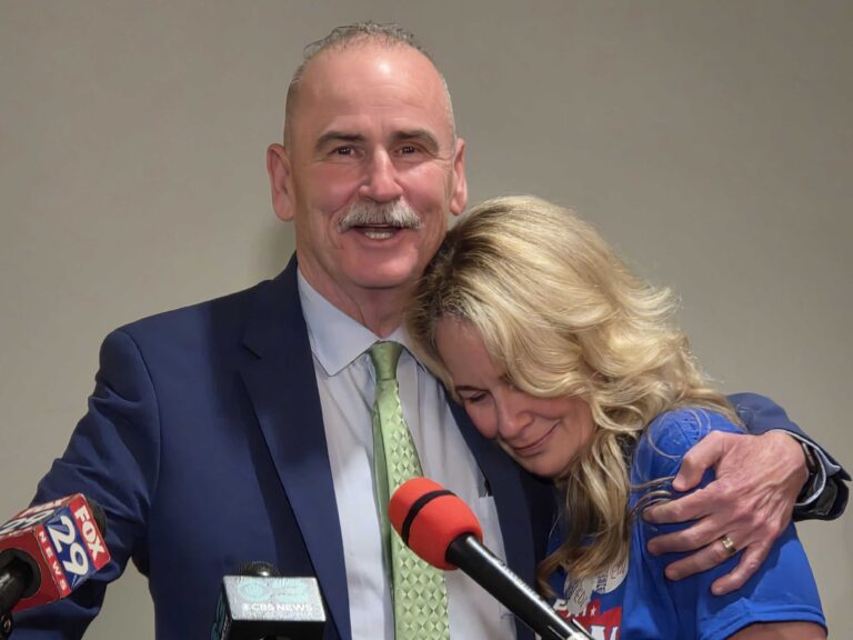 Pat Dugan hugs his wife