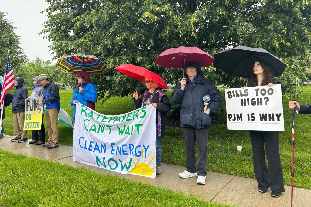 pjm-audubon-s-schmidt-2025-05-28-1 Protesters outside in the rain under umbrellas