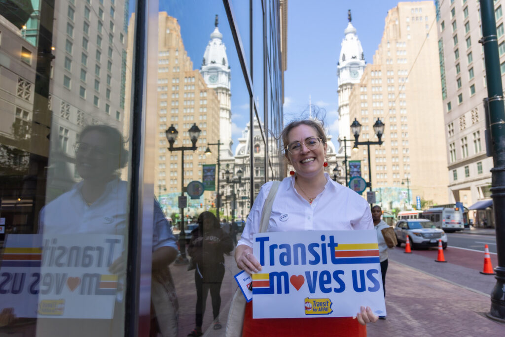 Leah Snyder outside SEPTA headquarters holding sign of support