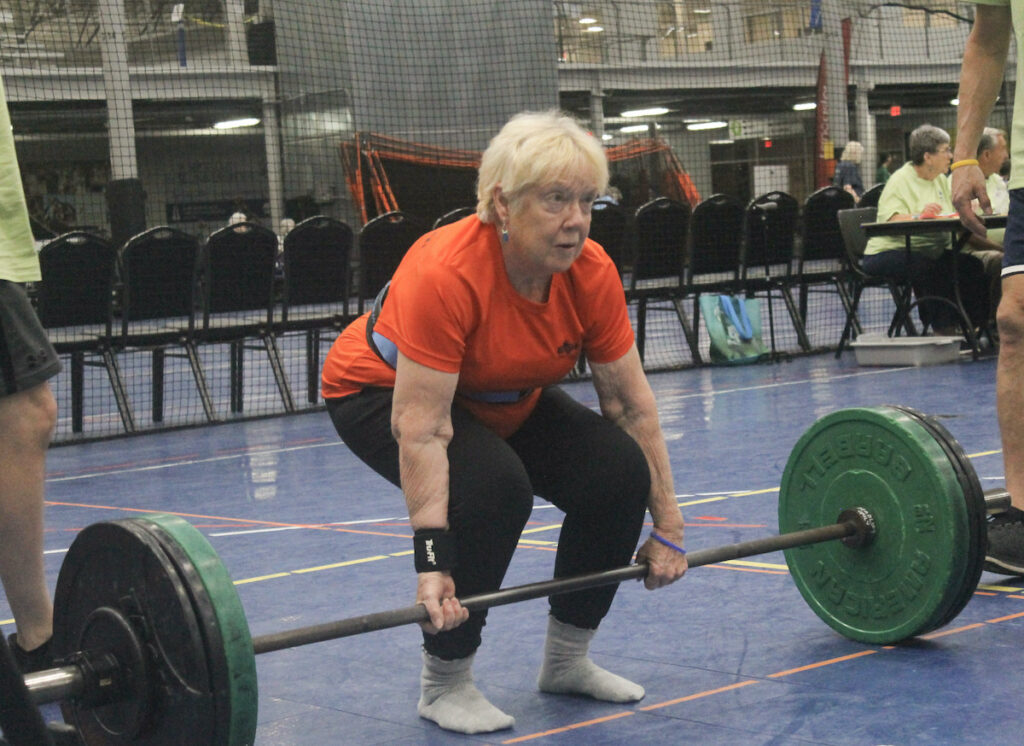 Judy Harding gets ready to lift a weighted barbell