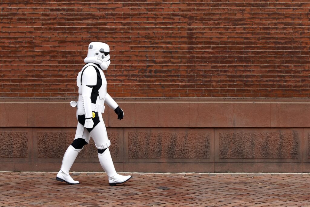 A person walking down the street dressed as a Stormtrooper