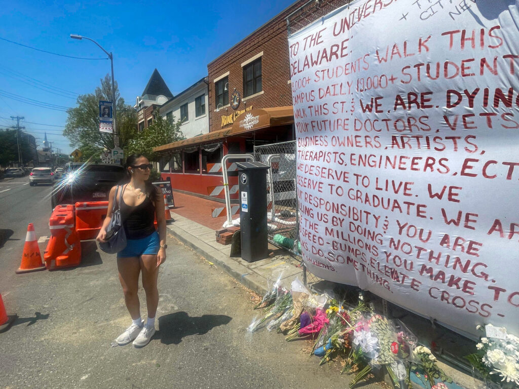 university-of-delaware-crash-site-2025 Crystal Sandoval stands by a memorial for the car crash at the University of Delaware