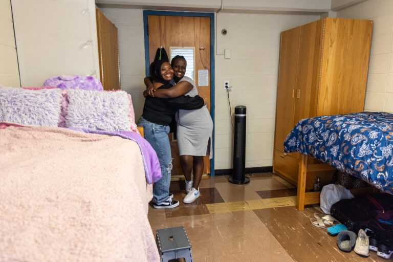 Roommates Chobe and Joy hug and smile at the HomeWorks Trenton
