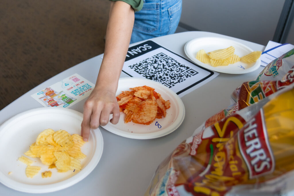 06-10-2025-k-paynter-herrs-chip-tasting-day-of-4 People reaching for chips on a plate