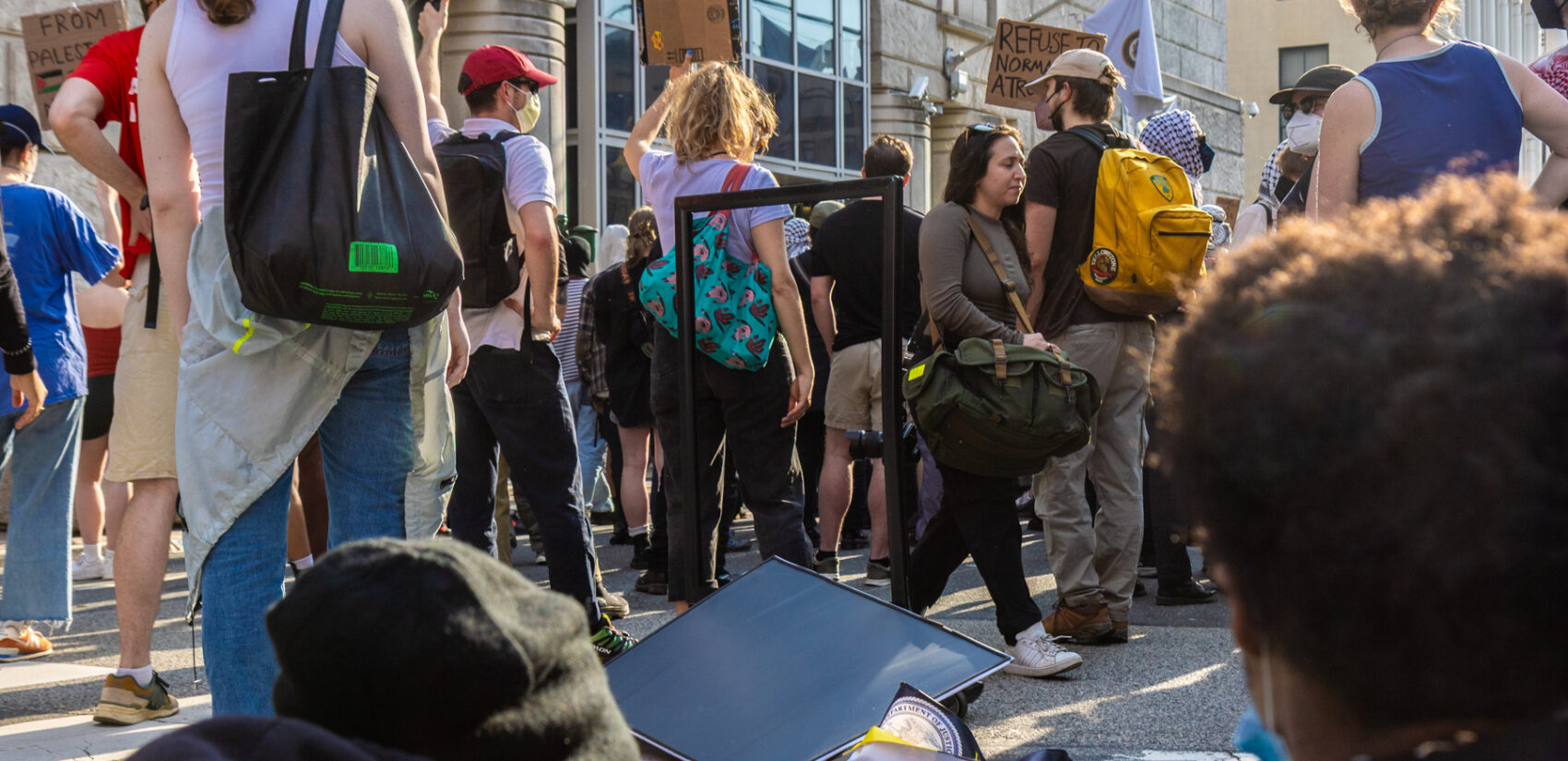 Protesters damage a metal sign outside the Federal Detention Center on Arch Street in Philadelphia on June 10, 2025.