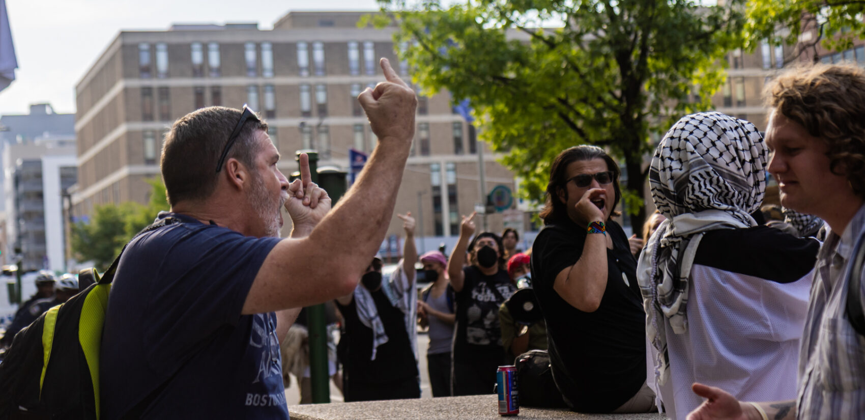 A pedestrian clashes with protesters against ICE raids Federal Detention Center on Arch Street in Philadelphia on June 10, 2025.